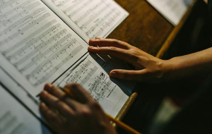 Sheet music being followed by Univ Music Society member